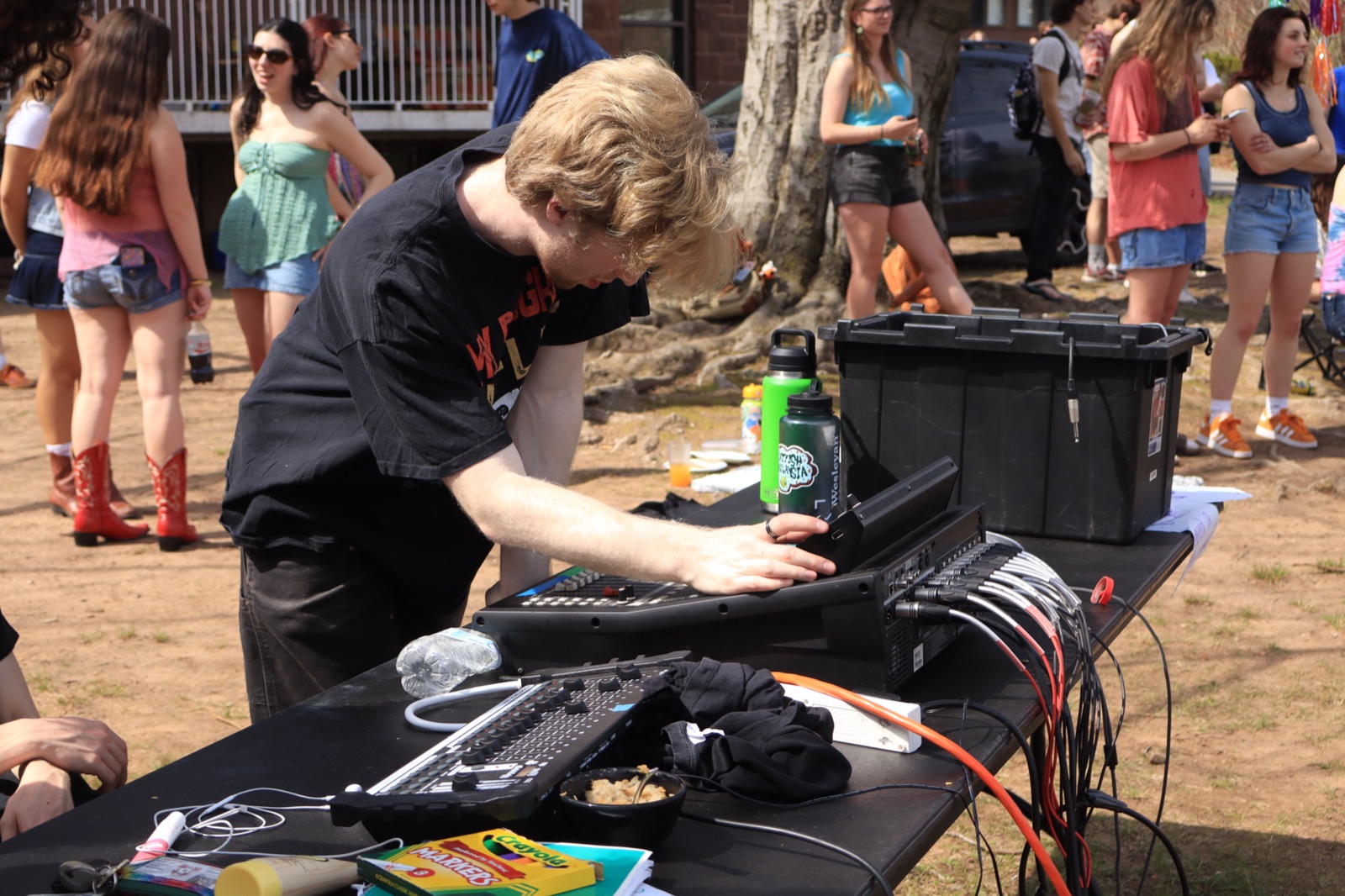 Benjamin Goodman running the mixing board at an outdoor show.